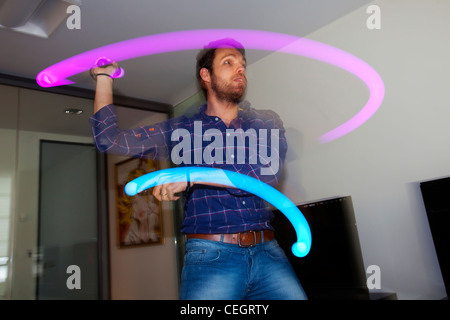 Man playing a video game with Sony`s PlayStation Move Motion Controller. Stock Photo